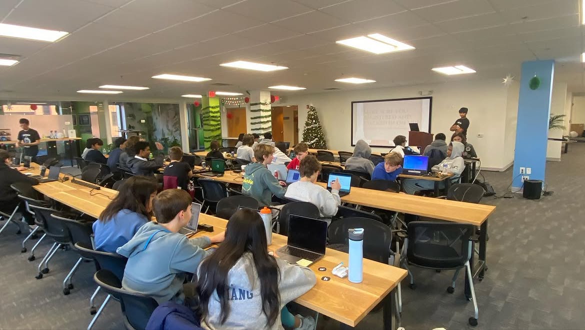 Hackers coding at tables
